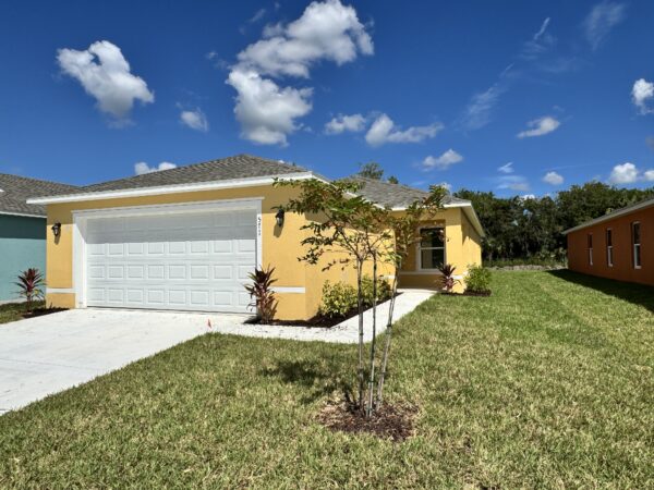 Richmond Cove Palm Bay Holiday Builders yellow house for sale