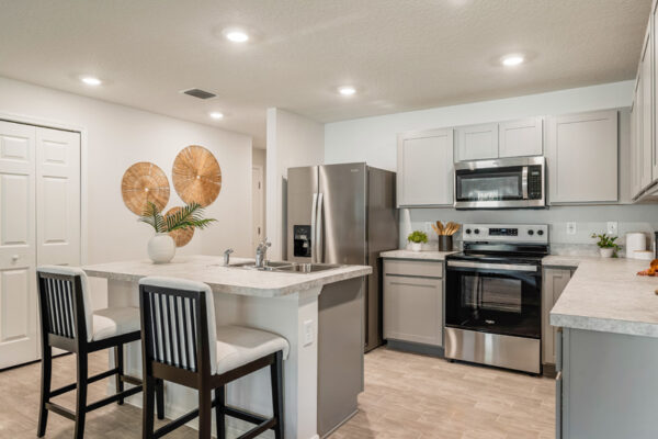 White kitchen view with island Holiday Builders model home