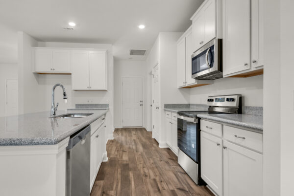 Stainless steel appliances in the Caliza kitchen from the Cornerstone collection by Holiday Builders.