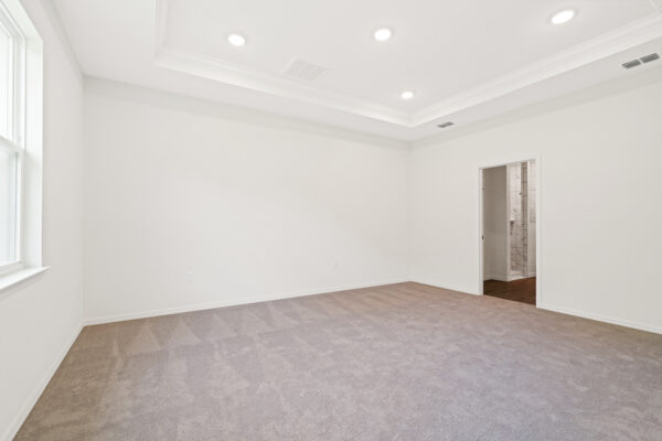 The master bedroom in the Cedar floorplan from the Cornerstone collection by Holiday Builders.
