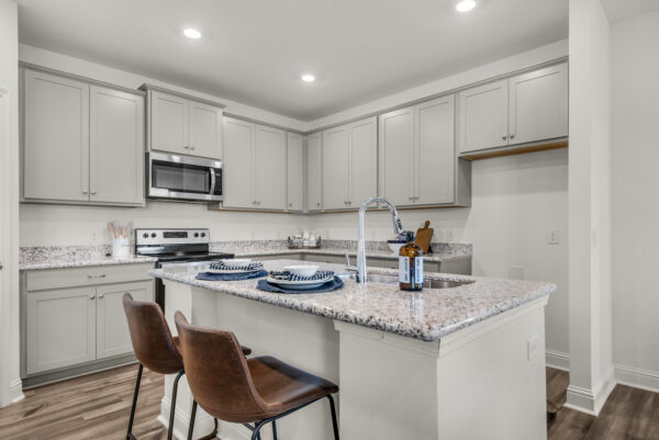 The kitchen in the Cypress floorplan from the Cornerstone collection by Holiday Builders.