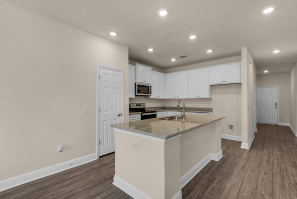 The kitchen of the Denham floorplan of the Cornerstone collection by Holiday Builders.