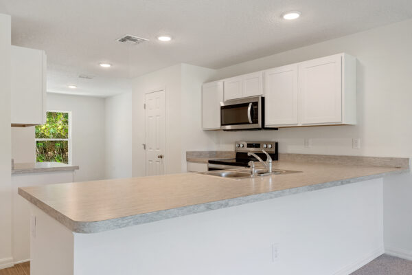 The kitchen island in the Foxtail floorplan from the Value collection by Holiday Builders.