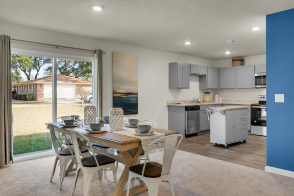 The dining area and kitchen in the Grayton floorplan from the Value collection by Holiday Builders.