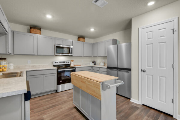 The gray kitchen in the Grayton floorplan from the Value collection by Holiday Builders.