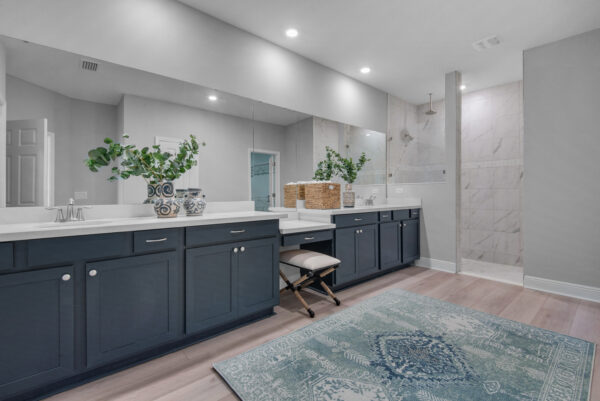 The spacious blue master bath in the Hamilton floorplan from the Cornerstone collection by Holiday Builders.