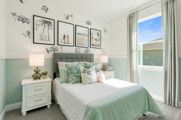 A green beach themed bedroom in the Highland floorplan from the Cornerstone collection by Holiday Builders.