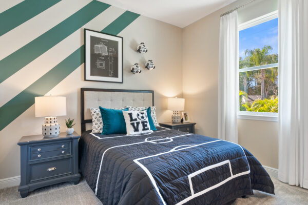 A soccer themed bedroom in the Highland floorplan from the Cornerstone collection by Holiday Builders.
