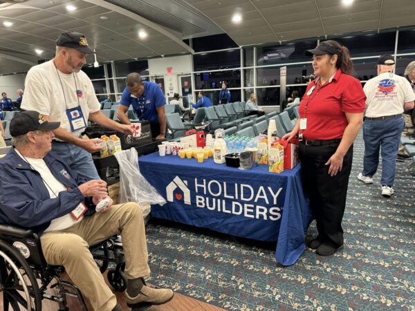 man and man in wheelchair at table with breakfast items
