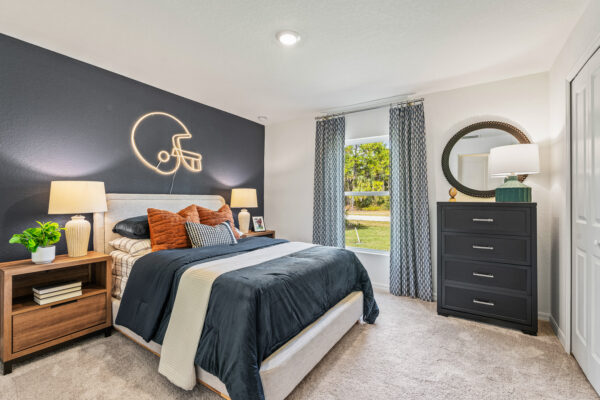 A boy's football themed bedroom in the Majestic floorplan from the Holiday Builders Value Collection
