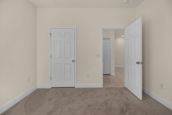 The guest bed in the Miramar floorplan from the Cornerstone Collection by Holiday Builders.