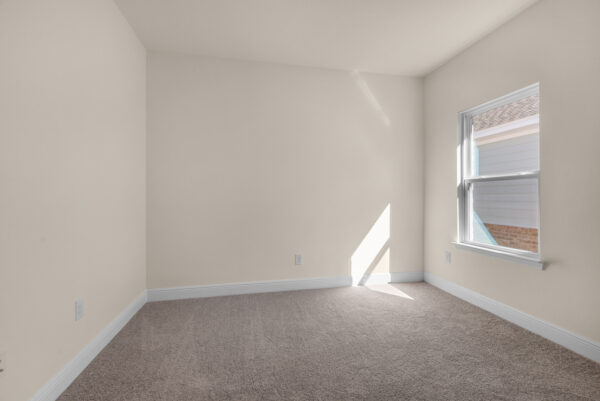 The guest bedroom in the Miramar floorplan from the Cornerstone Collection by Holiday Builders.