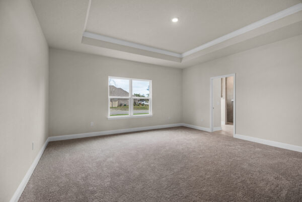 The owner's suite in the Osprey Floorplan from the Cornerstone Collection by Holiday Builders.