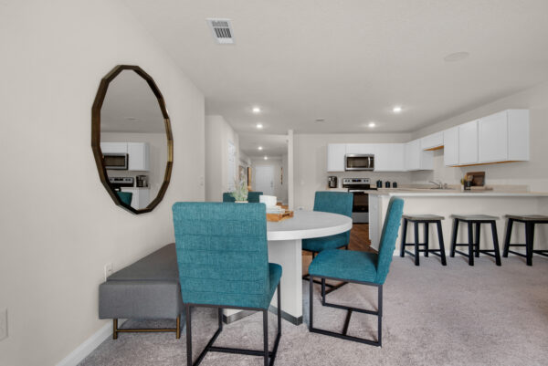 The dining and kitchen areas in the Palmer floorplan from the Value collection by Holiday Builders.