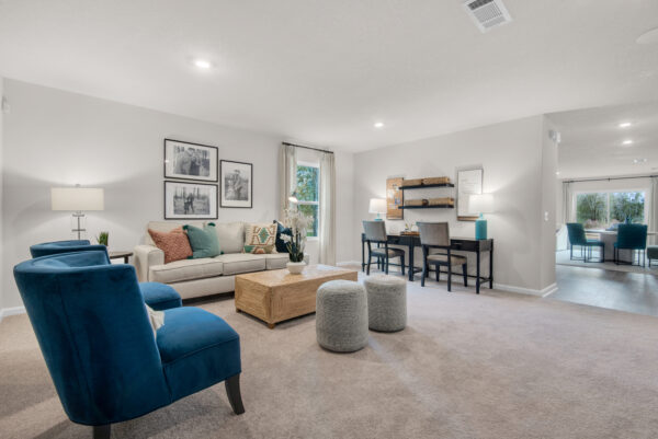 The living area in the Palmer floorplan from the Value collection by Holiday Builders.