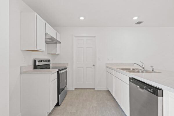 The kitchen galley in the Phoenix floorplan from the Inspire Collection by Holiday Builders.