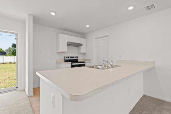 The kitchen in the Phoenix floorplan from the Inspire Collection by Holiday Builders.