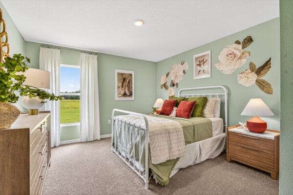 A girl's bedroom in the Queen floorplan from the Value Collection by Holiday Builders