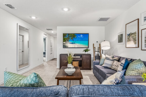 The living area in the Queen floorplan from the Value Collection by Holiday Builders