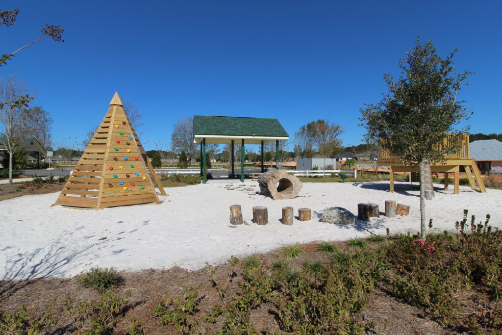 Children's playground area at Yellow River Ranch, a new home community in Milton, Florida featuring homes by Holiday Builders.