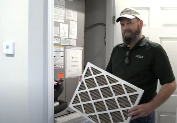 Man with air conditioner filter. 